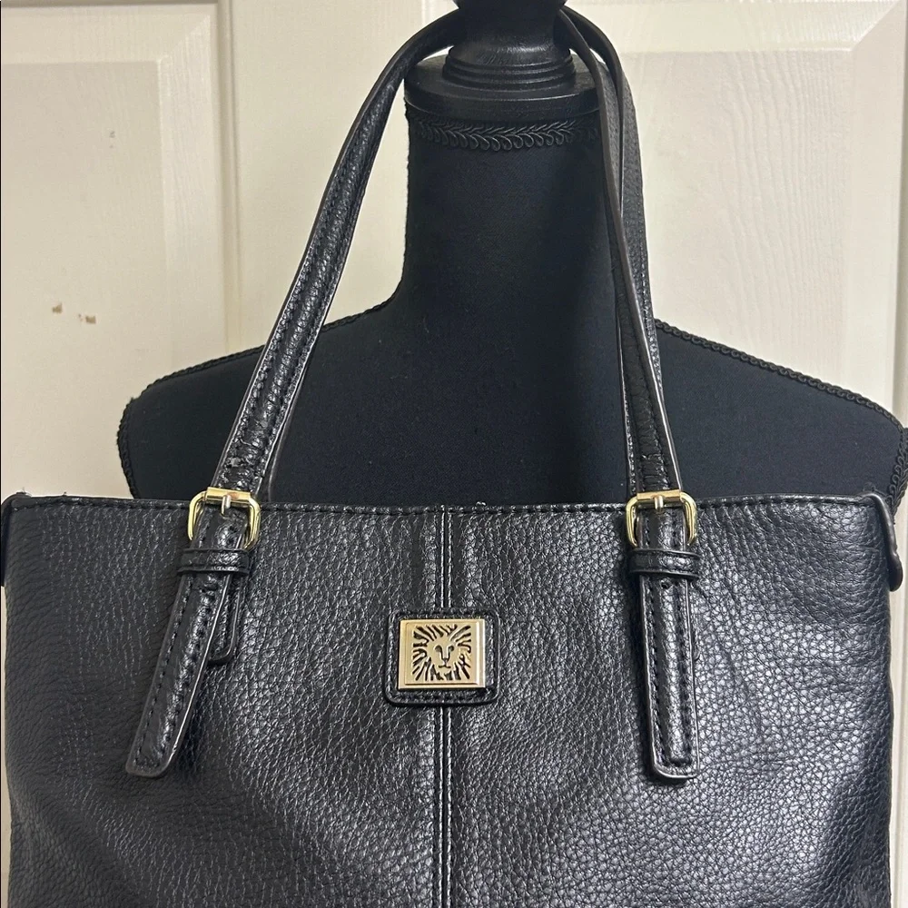 Anne Klein Black leather Tote with size pocket and adjustable straps. 13”x9 1/2”